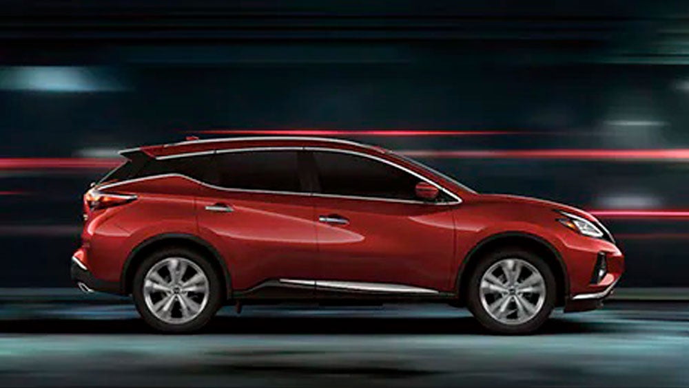 2023 Nissan Murano shown in profile driving down a street at night illustrating performance. | Gates Nissan of Richmond in Richmond KY