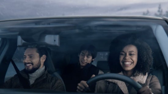 Three passengers riding in a vehicle and smiling | Gates Nissan of Richmond in Richmond KY